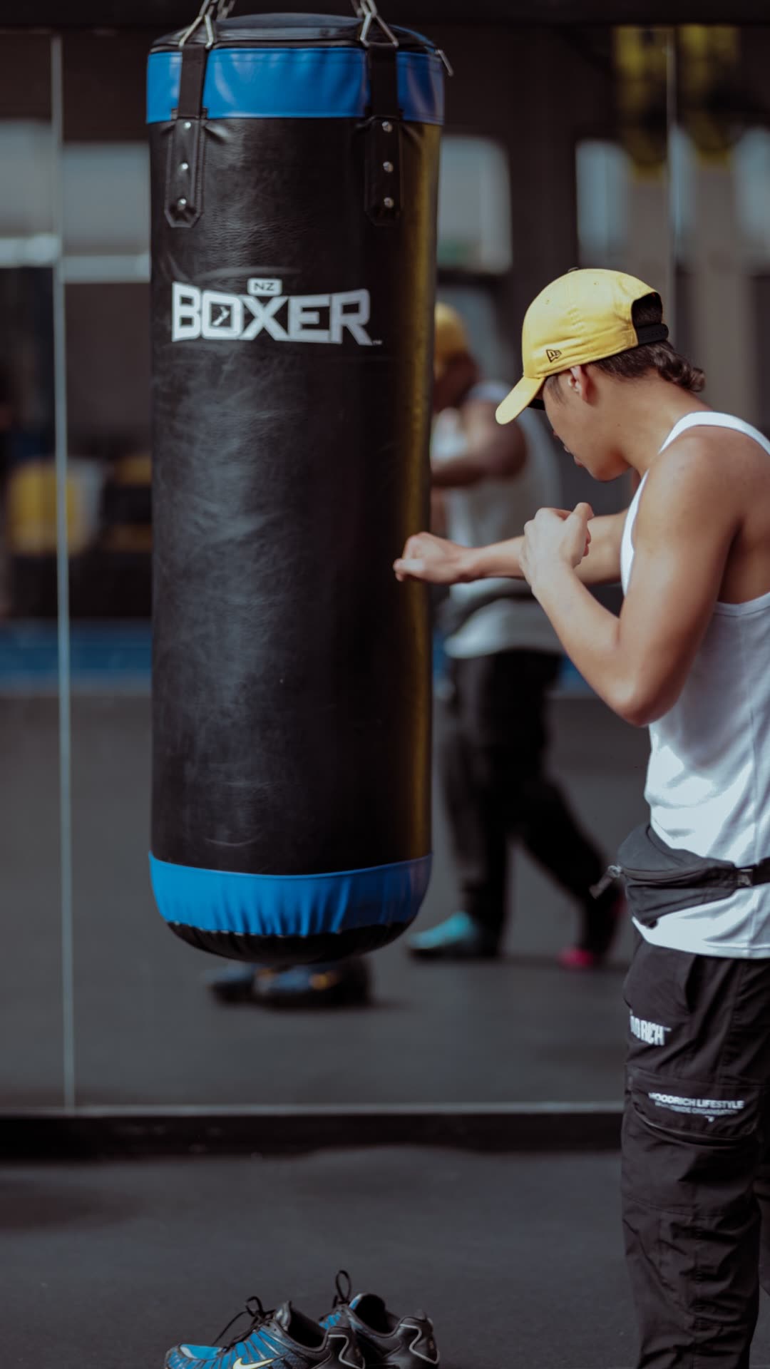 A young person training on a boxing bag as part of hauora and wellbeing